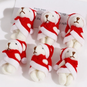 Detail of six plush white Christmas bears wearing red Santa hats and festive capes