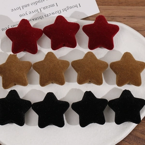 Detail of plush velvet star beads in red, brown, and black for DIY jewelry making