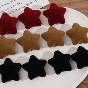 Detail view of velvet flocked star charms for DIY jewelry making in various colors