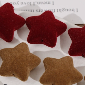 Macro detail of wine red flocked star beads with soft texture for DIY jewelry making