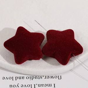 Burgundy velvet flocked star beads for DIY jewelry making displayed on a white tray