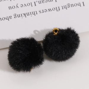 Detail of 20mm soft black plush pom-pom charms with gold metal loops for DIY jewelry
