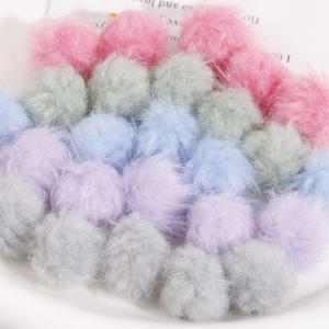 Pastel color faux fur pom-poms with glitter finish for DIY jewelry and crafts in a tray
