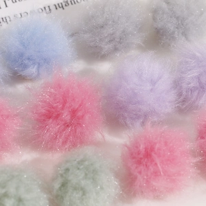 Macro shot of colorful plush craft balls with shiny glitter for DIY earring accessories