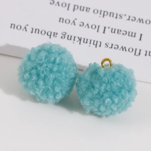 Détail de pompons en peluche bleu clair pour la fabrication de bijoux DIY et boucles