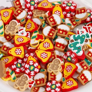 Close-up of assorted Christmas resin charms including gingerbread man and snowflake for DIY