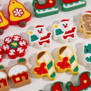 Macro view of Christmas resin charms including Santa, snowflakes and gingerbread man