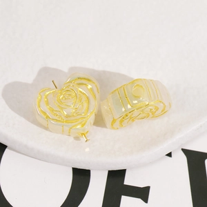 Macro view of iridescent heart-shaped rose beads with gold edges for DIY jewelry