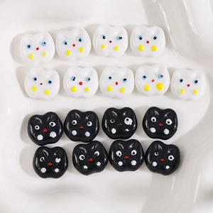 Macro view of cute acrylic cat charm beads for DIY jewelry making in black and white
