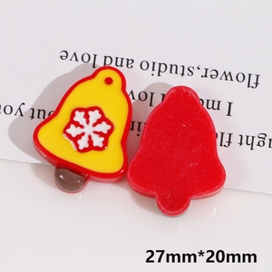 Macro detail of 27x20mm Christmas bell resin flatback charm with snowflake for DIY crafts