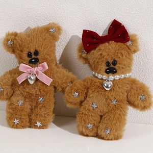 Detail of plush brown bears with velvet bows and sparkling silver star sequins