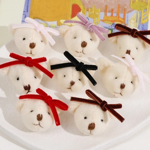 Close-up of cute plush bear heads with velvet bows for DIY hair accessories