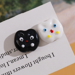 Macro shot of colorful acrylic cat beads with glossy finish for DIY jewelry crafting