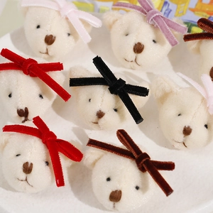Detail of plush cream bear charms with colorful velvet bows for DIY hair accessories