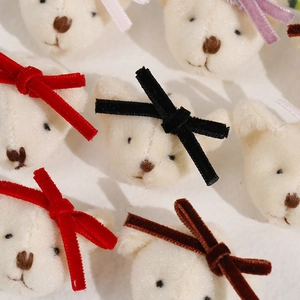 Close-up of plush bear DIY accessories with colorful velvet bows for hair ornaments