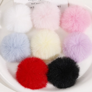 Detailed view of 50mm soft faux rabbit fur pompoms in eight vibrant assorted colors