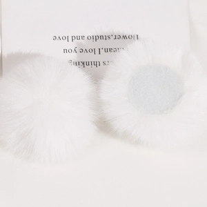 Detailed view of 50mm soft faux rabbit fur pom poms showing fluffy texture and flat back