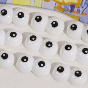 Macro view of cartoon big eyes flatback resin cabochons for DIY accessory crafts
