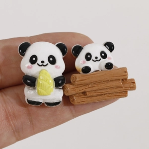 Cute resin panda figurines holding bamboo shoots and resting on logs for DIY crafts