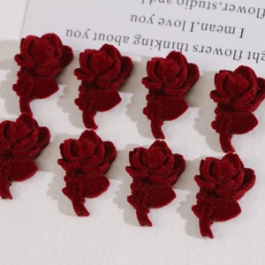 Close-up of 8 burgundy flocked rose acrylic charms for DIY earring and jewelry making