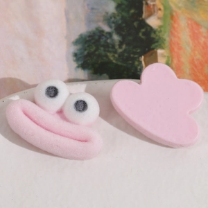 Vue macro de breloques de dessin animé floquées roses et accessoires de bricolage en résine