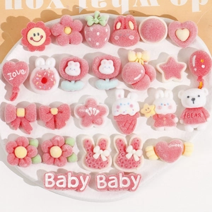Close-up of pink flocked resin patches in heart, bear, and flower shapes for DIY crafts