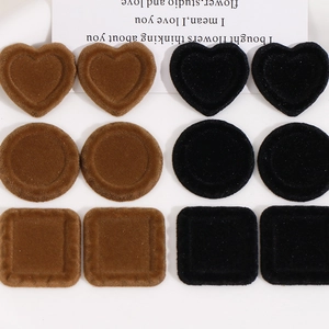 Detail of flocked geometric heart and square resin charms for DIY jewelry making