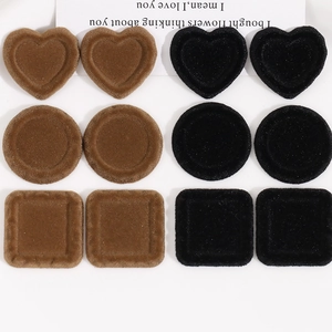Macro detail of flocking resin DIY jewelry charms in heart and geometric shapes