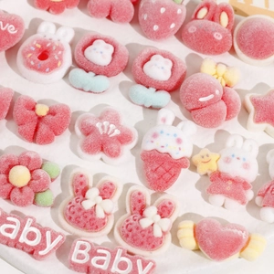 Detailed macro view of assorted pink flocked resin DIY charms with bunny and flower shapes