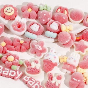 Pink and white DIY resin charms with flocking texture including bunnies and floral shapes