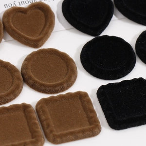 Macro detail of flocked geometric heart and round resin DIY jewelry craft accessories