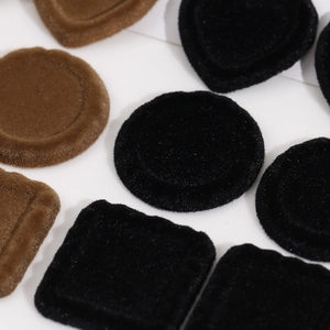 Macro shot of flocked heart and geometric shapes in dark brown and black finishes