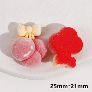Close-up of red flocked resin flower and pink round bow charms for DIY accessories