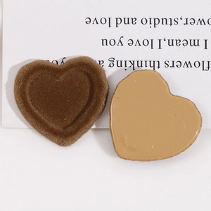 Detailed view of heart-shaped flocked resin charms with soft brown velvet texture for DIY jewelry