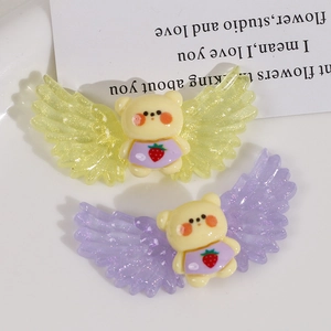 Detailed macro view of cute resin bear charms with glitter angel wings for DIY crafts