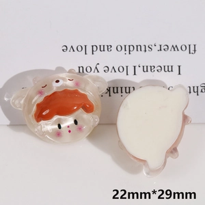 Macro view of cartoon monster resin charm showing 22mm by 29mm size and flat back