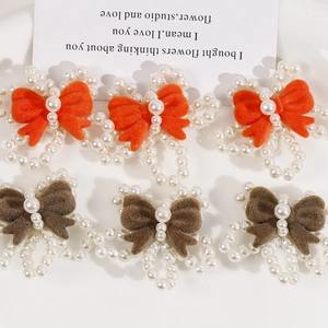 Detail of handmade flocked bow accessories with pearl beads for DIY hair jewelry crafts