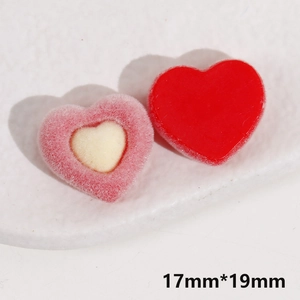 Macro detail of red glossy and pink flocked heart resin charms for DIY jewelry making