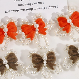 Close-up of handmade velvet bow hair accessories with elegant pearl bead detailing