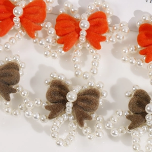 Macro shot of handmade beaded faux pearl hair accessory with velvet bow accents