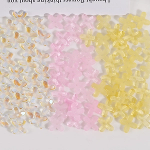 Macro view of gradient four-petal flower glass beads for DIY jewelry making