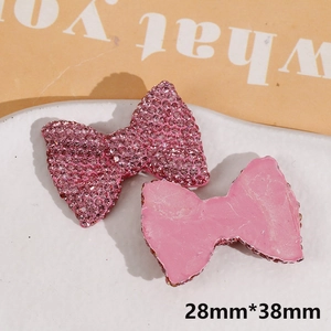Detailed view of pink resin bow DIY charm with shiny rhinestones, size 28mm x 38mm