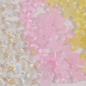 Macro view of gradient glass osmanthus beads with central hole for DIY jewelry making