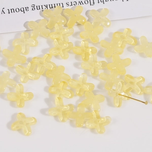 Macro view of translucent light yellow glass flower beads for DIY jewelry making