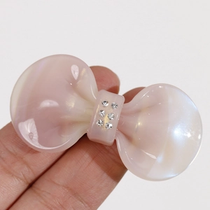 Pearlescent pink marble acetate bow hair claw clip with sparkling rhinestones decoration