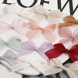 Macro view of assorted glitter tulle mesh bow hair clips in various vibrant colors