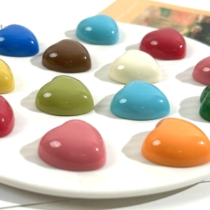 Vibrant glossy resin heart cabochons in various colors for DIY crafts and accessories