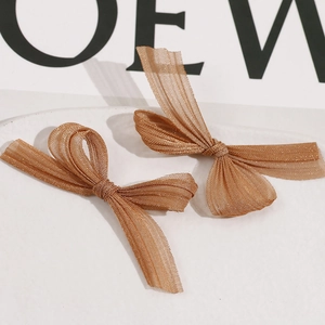 Detailed view of handmade mesh butterfly hair clips with shimmering translucent texture