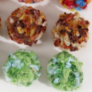 Macro detail of 30mm colorful fluffy plush cotton yarn balls for DIY jewelry and crafts