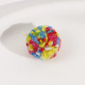 Macro detail of soft 30mm colorful plush pom-poms for DIY jewelry and crafts making